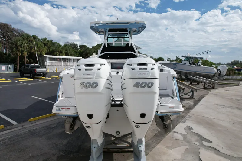  Yacht Photos Pics 2023 Blackfin 332 CC boat with twin 400 horsepower engines, parked on a trailer.