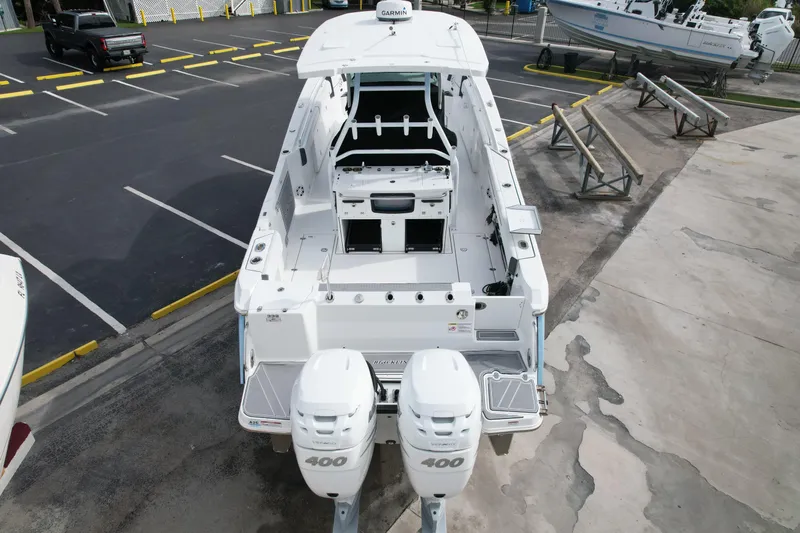  Yacht Photos Pics 2023 Blackfin 332 CC boat with dual 400 engines, parked in a marina.