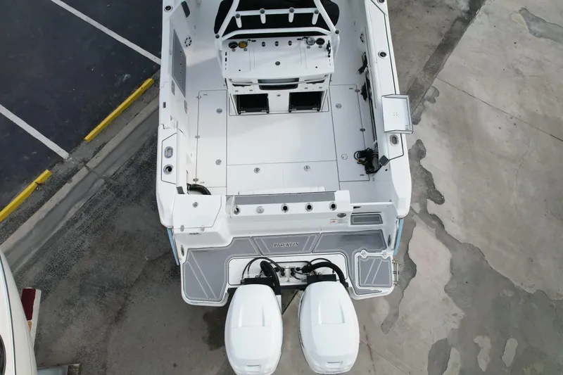  Yacht Photos Pics Overhead view of 2023 Blackfin 332 CC boat with dual engines in a parking area.