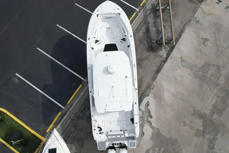  Yacht Photos Pics Aerial view of 2023 Blackfin 332 CC boat parked on concrete surface.