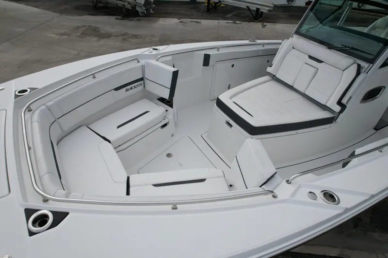  Yacht Photos Pics 2023 Blackfin 332 CC boat interior with white cushioned seating and sleek design.