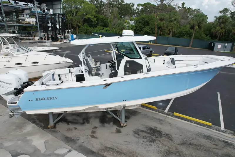  Yacht Photos Pics 2023 Blackfin 332 CC boat in light blue, docked at a marina.