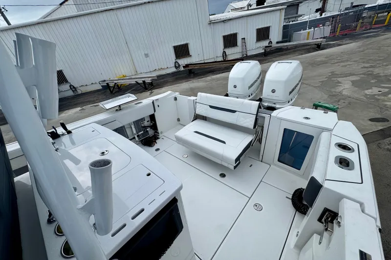  Yacht Photos Pics 2023 Blackfin 332 CC boat interior with dual Mercury engines and seating area.