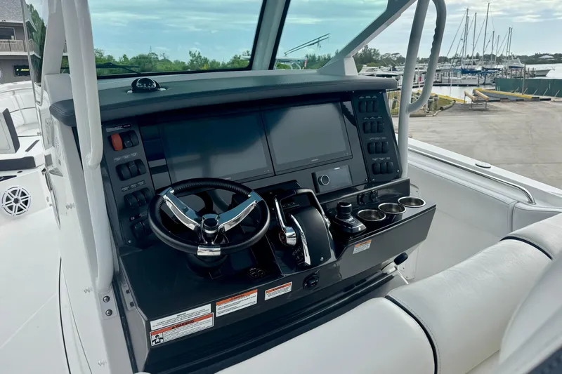  Yacht Photos Pics 2023 Blackfin 332 CC boat helm with modern controls and navigation system.
