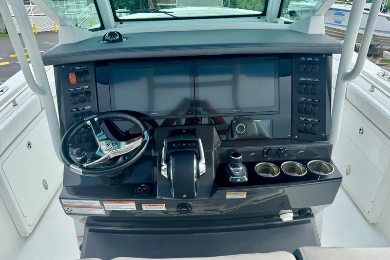  Yacht Photos Pics 2023 Blackfin 332 CC helm with dual screens, steering wheel, and control panel.