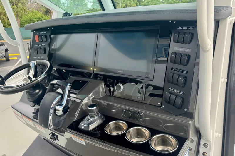  Yacht Photos Pics 2023 Blackfin 332 CC helm with dual screens, controls, and cup holders.