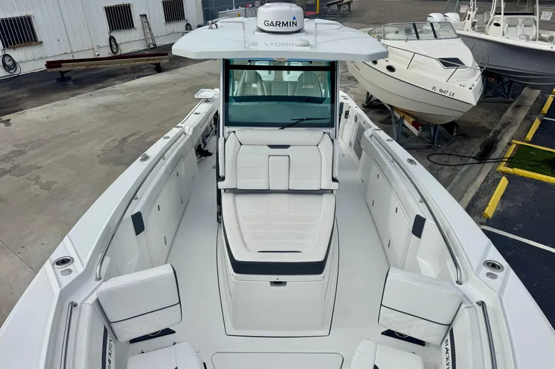  Yacht Photos Pics 2023 Blackfin 332 CC boat with Garmin equipment, docked in a marina.