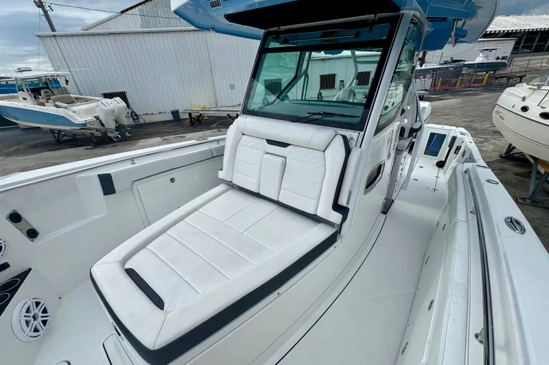 Yacht Photos Pics 2023 Blackfin 332 CC boat with white seating and sleek design at a marina.