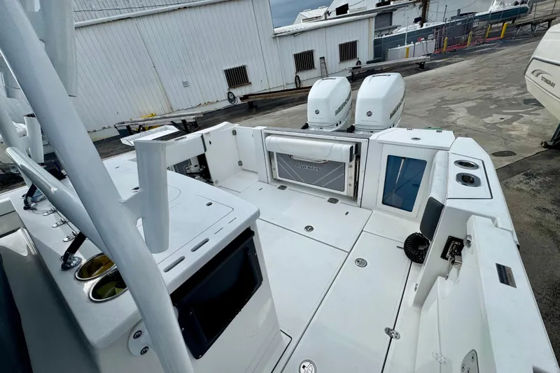  Yacht Photos Pics 2023 Blackfin 332 CC boat with dual engines, docked at a marina.