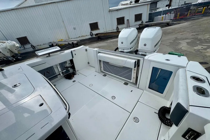  Yacht Photos Pics 2023 Blackfin 332 CC boat with dual Mercury engines at a dock.