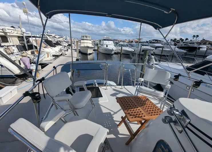 Watershed Yacht Photos Pics 2014 Nordic Tug 34 Pilothouse yacht docked at marina, featuring spacious outdoor seating area.