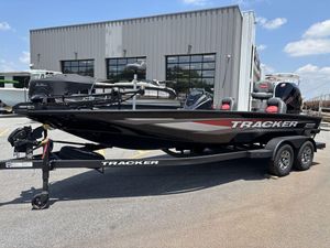2025 Tracker SAVAGE™ 215 boat on trailer, parked outside a building under a clear sky.