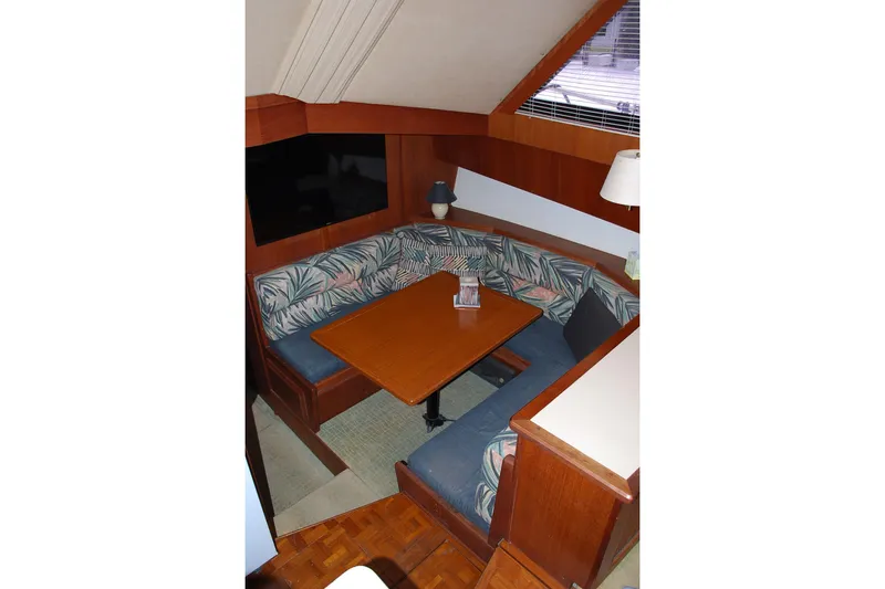 2 Jay's Yacht Photos Pics 1988 Viking 45 Convertible yacht interior with cozy dining area and patterned seating.
