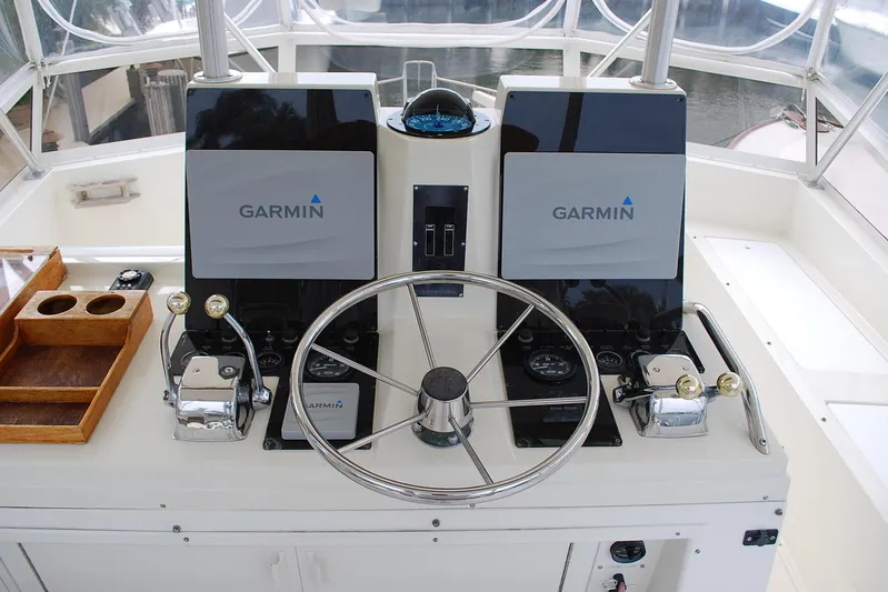 2 Jay's Yacht Photos Pics 1988 Viking 45 Convertible helm with Garmin navigation, dual controls, and steering wheel.