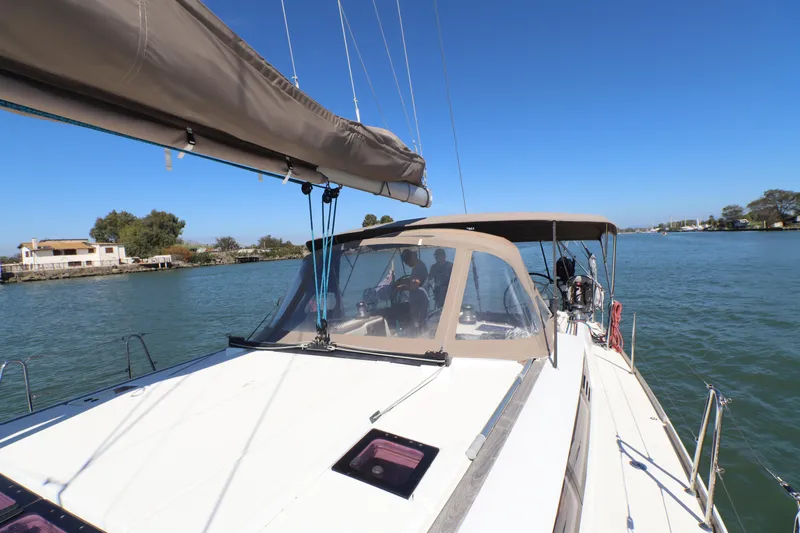 Marley 2 Yacht Photos Pics 2012 Jeanneau Sun Odyssey 509 sailing on a calm river under clear blue skies.