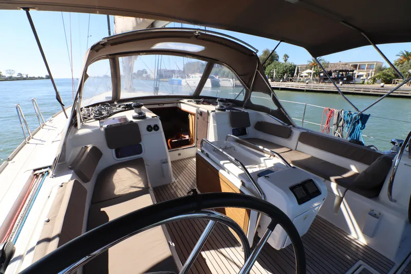 Marley 2 Yacht Photos Pics 2012 Jeanneau Sun Odyssey 509 sailboat cockpit with seating, steering wheel, and marina view.
