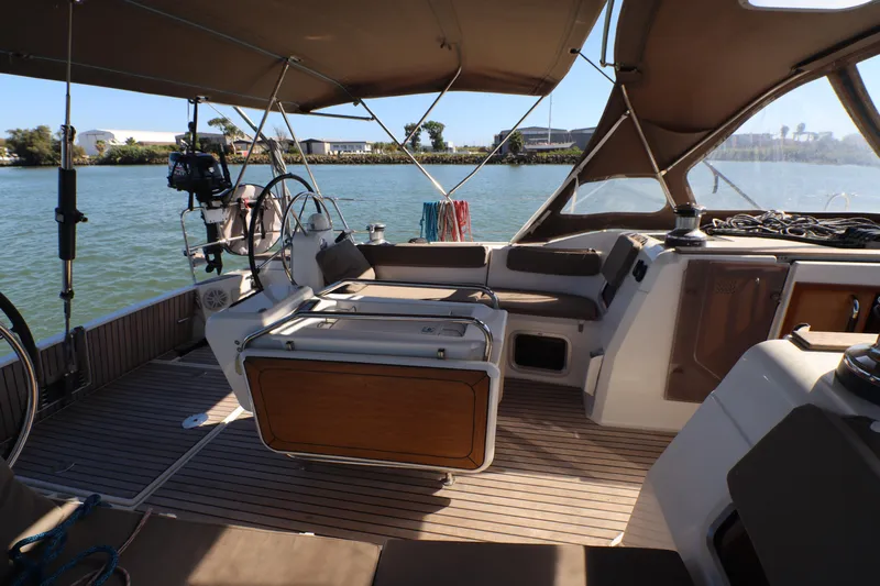 Marley 2 Yacht Photos Pics 2012 Jeanneau Sun Odyssey 509 cockpit with steering wheel, seating, and canopy on calm water.
