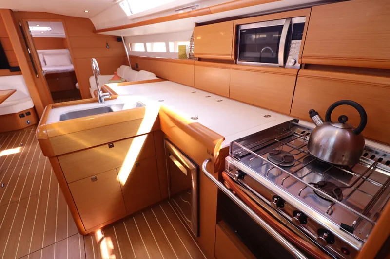 Marley 2 Yacht Photos Pics Luxurious kitchen interior of 2012 Jeanneau Sun Odyssey 509 yacht with modern amenities.
