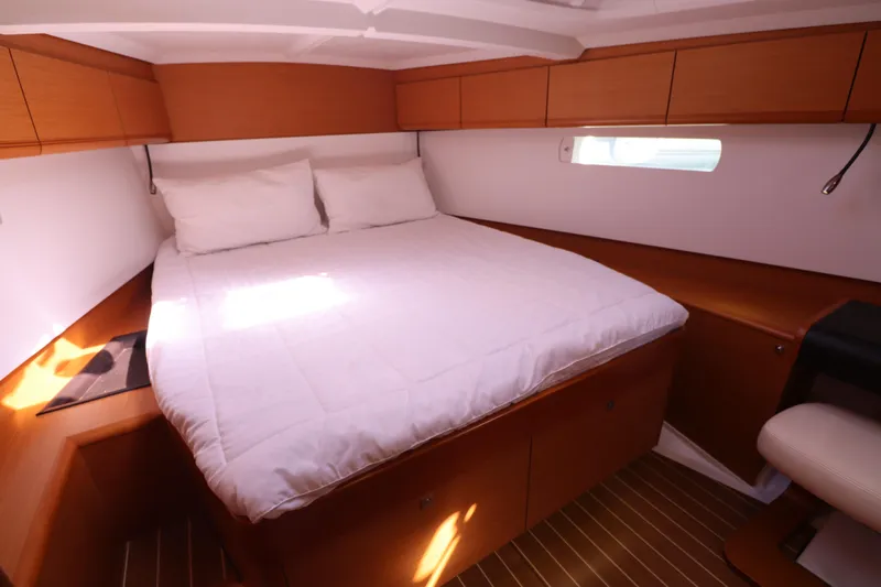 Marley 2 Yacht Photos Pics Cozy cabin interior of 2012 Jeanneau Sun Odyssey 509 with wooden finish and comfortable bedding.