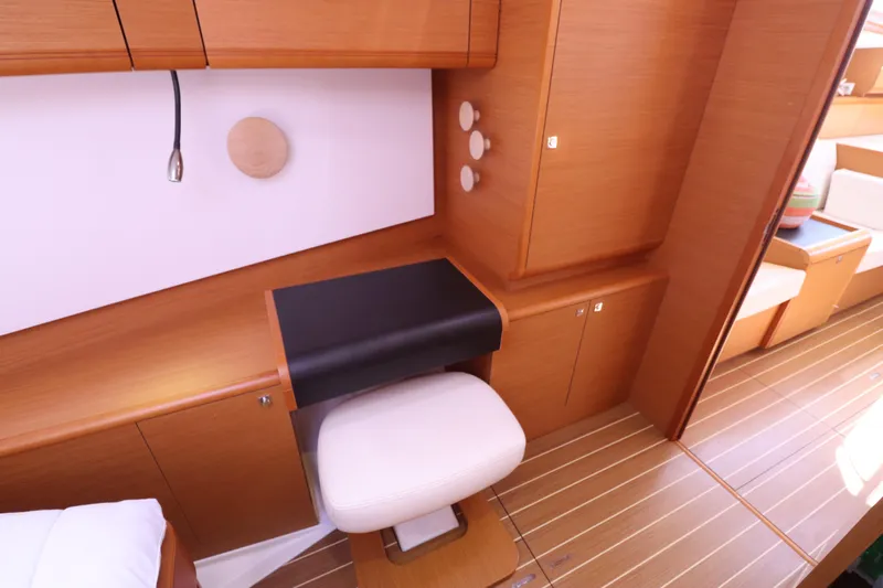 Marley 2 Yacht Photos Pics Interior of 2012 Jeanneau Sun Odyssey 509 yacht with wooden cabinetry and seating.