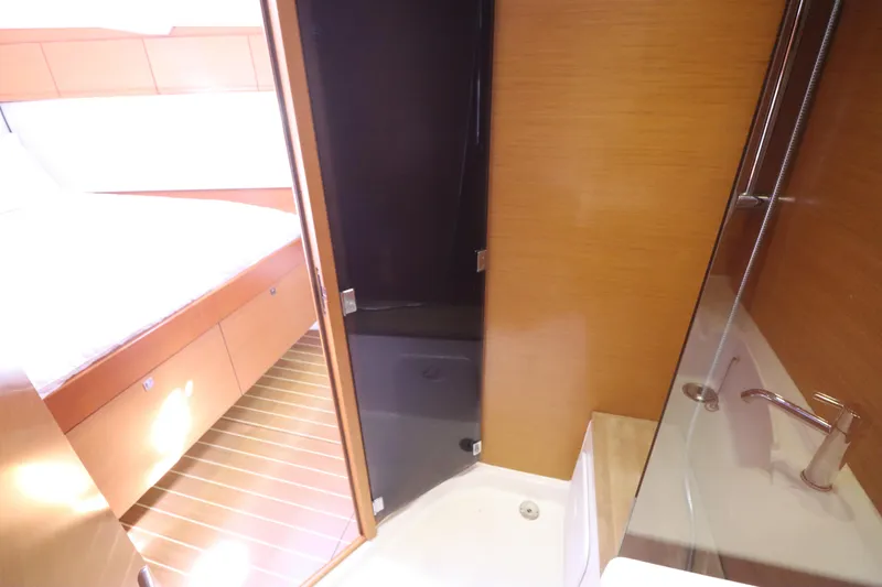 Marley 2 Yacht Photos Pics Interior of 2012 Jeanneau Sun Odyssey 509 yacht, featuring a cozy cabin and modern bathroom.
