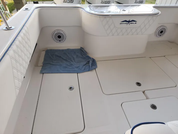 Yacht Photos Pics 2013 Invincible 36 Open Fisherman boat interior with storage compartments and towel.