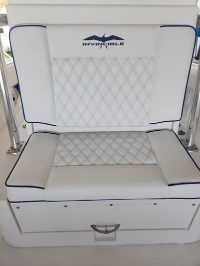  Yacht Photos Pics White cushioned seat on 2013 Invincible 36 Open Fisherman boat, featuring diamond pattern stitching.