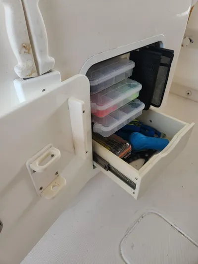  Yacht Photos Pics Storage compartment with fishing gear on a 2013 Invincible 36 Open Fisherman boat.