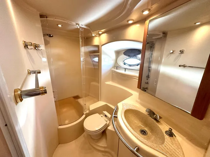 The Mystic Yacht Photos Pics Luxurious bathroom in 2001 Maxum 4600 SCB yacht, featuring shower, sink, and porthole window.