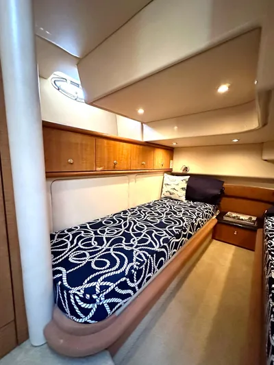 The Mystic Yacht Photos Pics 2001 Maxum 4600 SCB Limited Edition cabin with nautical-themed bedding and wooden cabinetry.