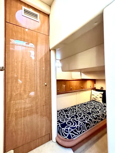 The Mystic Yacht Photos Pics 2001 Maxum 4600 SCB Limited Edition cabin with wood paneling and patterned bedding.