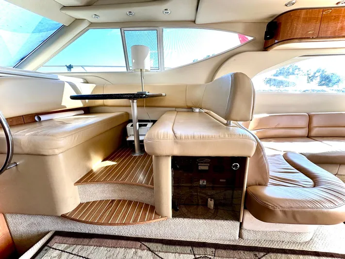 The Mystic Yacht Photos Pics Luxurious interior of 2001 Maxum 4600 SCB yacht with beige leather seating and wooden accents.