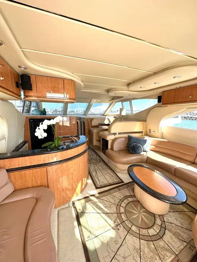 The Mystic Yacht Photos Pics Luxurious interior of 2001 Maxum 4600 SCB yacht with elegant wood finishes and plush seating.