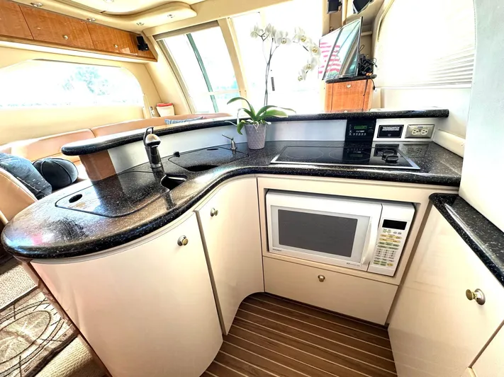 The Mystic Yacht Photos Pics Luxurious kitchen in 2001 Maxum 4600 SCB yacht with modern appliances and elegant design.