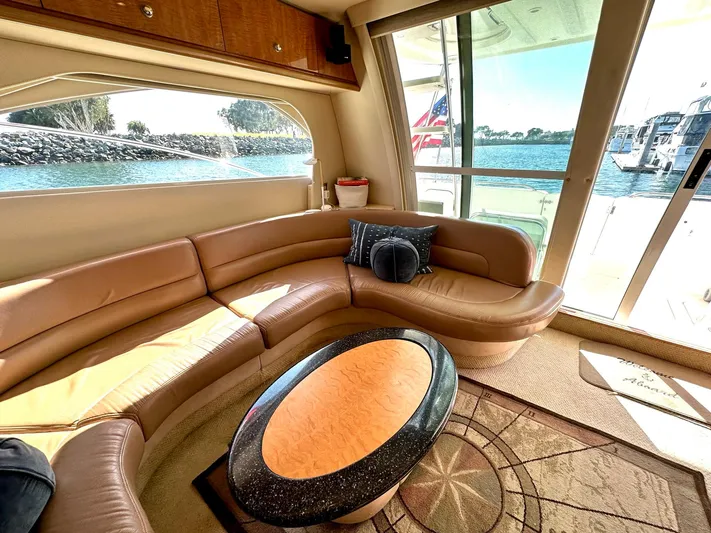 The Mystic Yacht Photos Pics Luxurious interior of 2001 Maxum 4600 SCB yacht with leather seating and waterfront view.
