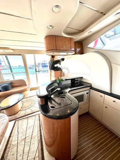 The Mystic Yacht Photos Pics Luxurious 2001 Maxum 4600 SCB yacht interior with modern kitchen and elegant design.