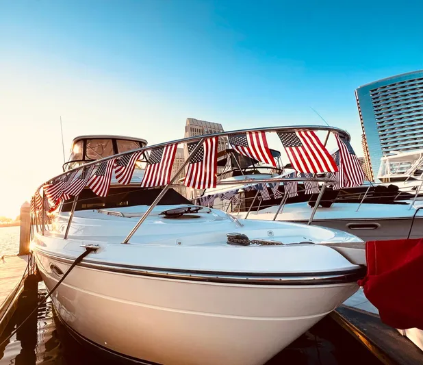 The Mystic Yacht Photos Pics 2001 Maxum 4600 SCB Limited Edition yacht adorned with American flags at sunset.
