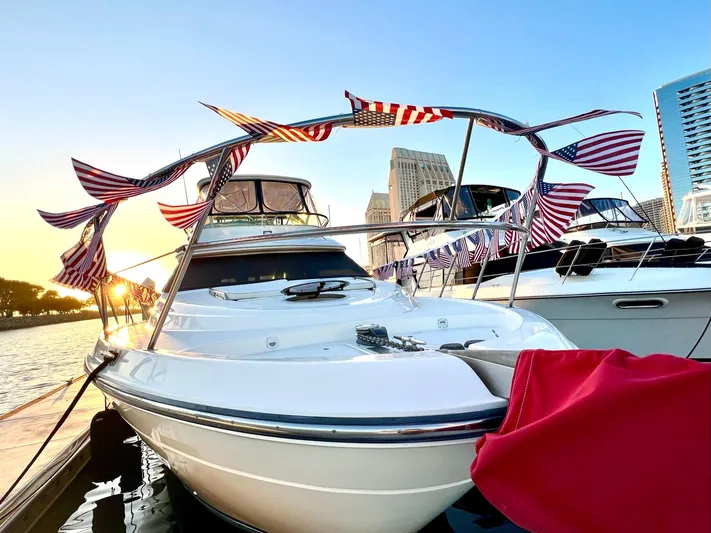 The Mystic Yacht Photos Pics 2001 Maxum 4600 SCB Limited Edition yacht docked, adorned with flags, at sunset.
