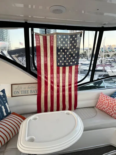 The Mystic Yacht Photos Pics American flag displayed inside 2001 Maxum 4600 SCB Limited Edition yacht with cozy seating.