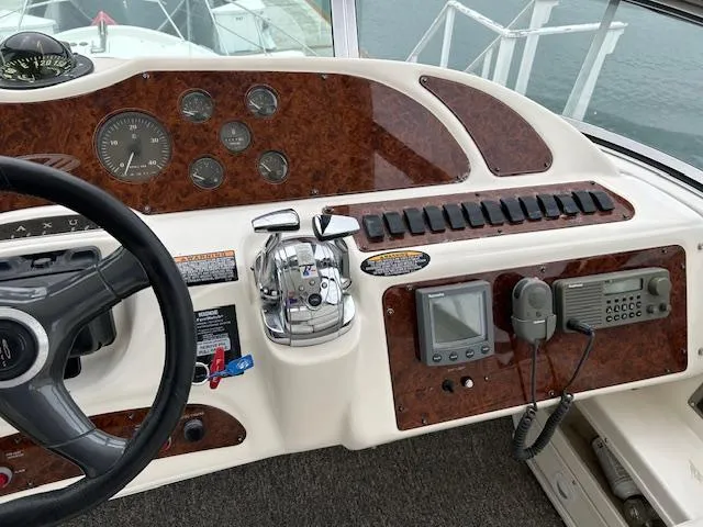 The Mystic Yacht Photos Pics Control panel of a 2001 Maxum 4600 SCB Limited Edition yacht with steering wheel and navigation instruments.