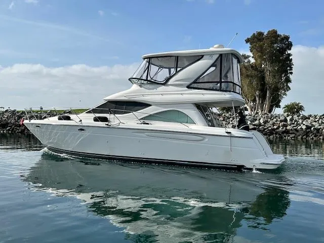 The Mystic Yacht Photos Pics 2001 Maxum 4600 SCB Limited Edition yacht on calm water, clear sky background.