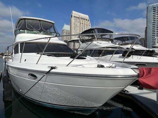 The Mystic Yacht Photos Pics 2001 Maxum 4600 SCB Limited Edition yacht docked in a marina, with city skyline background.