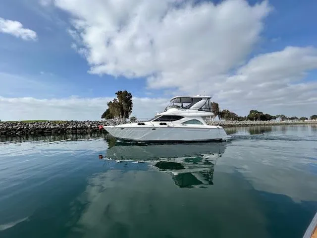 The Mystic Yacht Photos Pics 2001 Maxum 4600 SCB Limited Edition yacht on calm water under a cloudy sky.