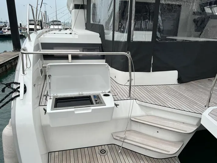  Yacht Photos Pics 2023 Lagoon 55 yacht with open deck grill and sleek design.