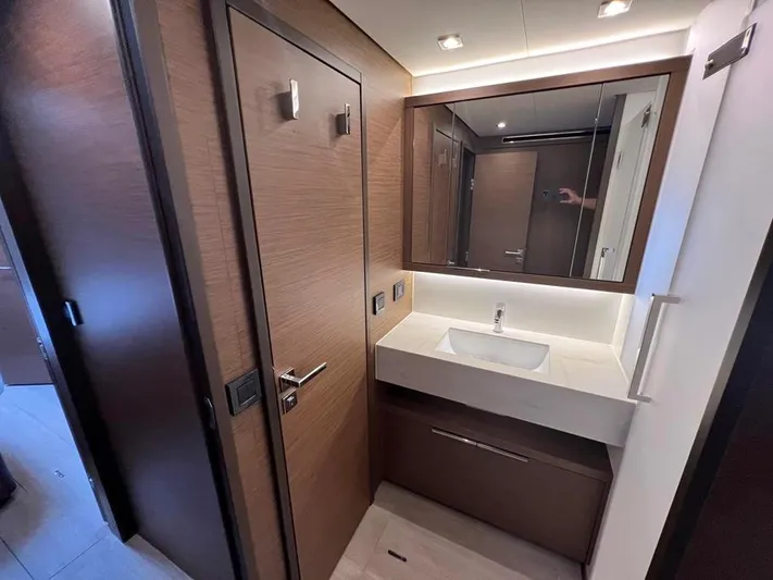  Yacht Photos Pics Modern bathroom interior on 2023 Lagoon 55 yacht, featuring sleek wood finishes and a stylish sink.