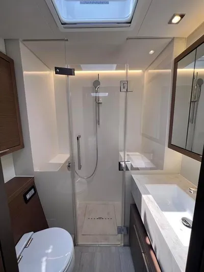  Yacht Photos Pics Modern bathroom in 2023 Lagoon 55 yacht with glass shower and skylight.