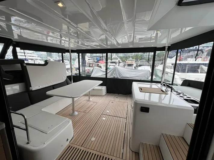  Yacht Photos Pics Spacious interior of 2023 Lagoon 55 yacht with seating and table.