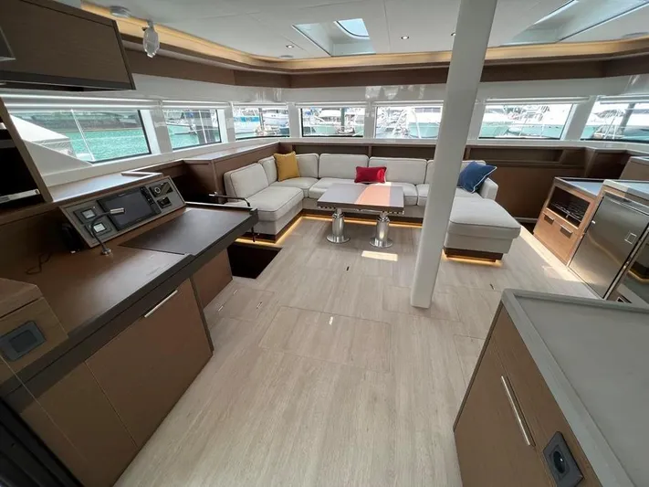  Yacht Photos Pics Luxurious interior of 2023 Lagoon 55 yacht with modern furnishings and panoramic windows.