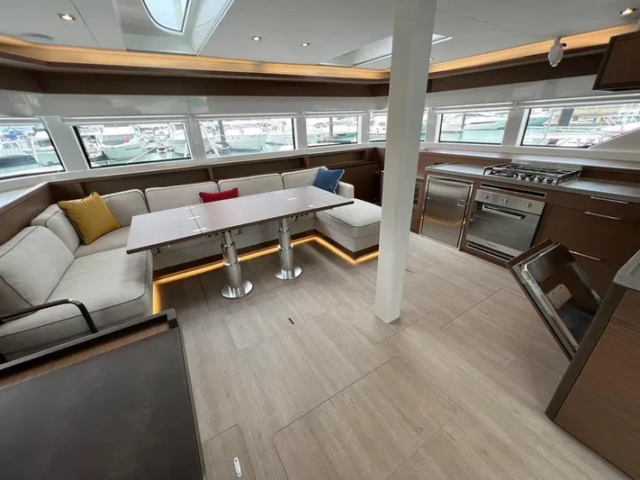  Yacht Photos Pics Luxurious interior of 2023 Lagoon 55 yacht with modern kitchen and seating area.