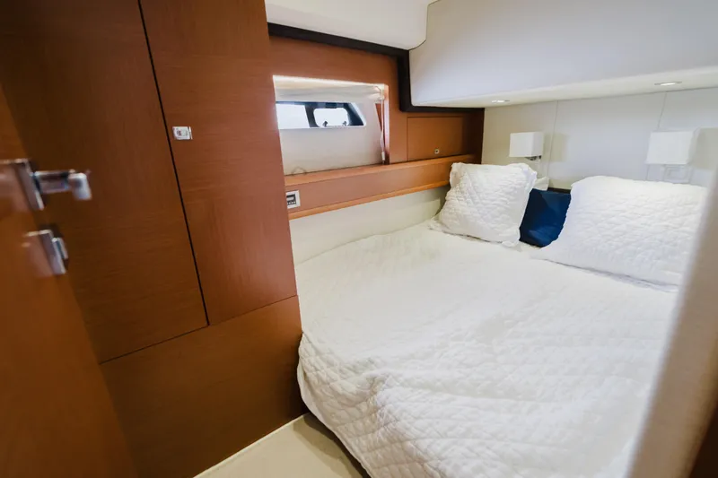 Worldwide Yacht Photos Pics Luxurious cabin interior of 2014 Prestige 620 Fly yacht with cozy bedding.